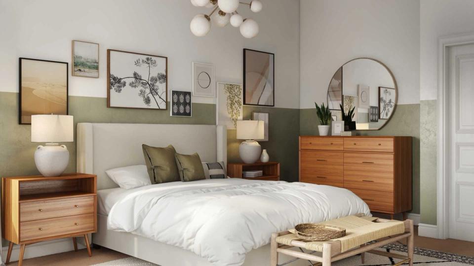 Mid-century bedroom with sage green accent wall, warm wood furniture, and gallery wall art creating a calm, organized retreat.