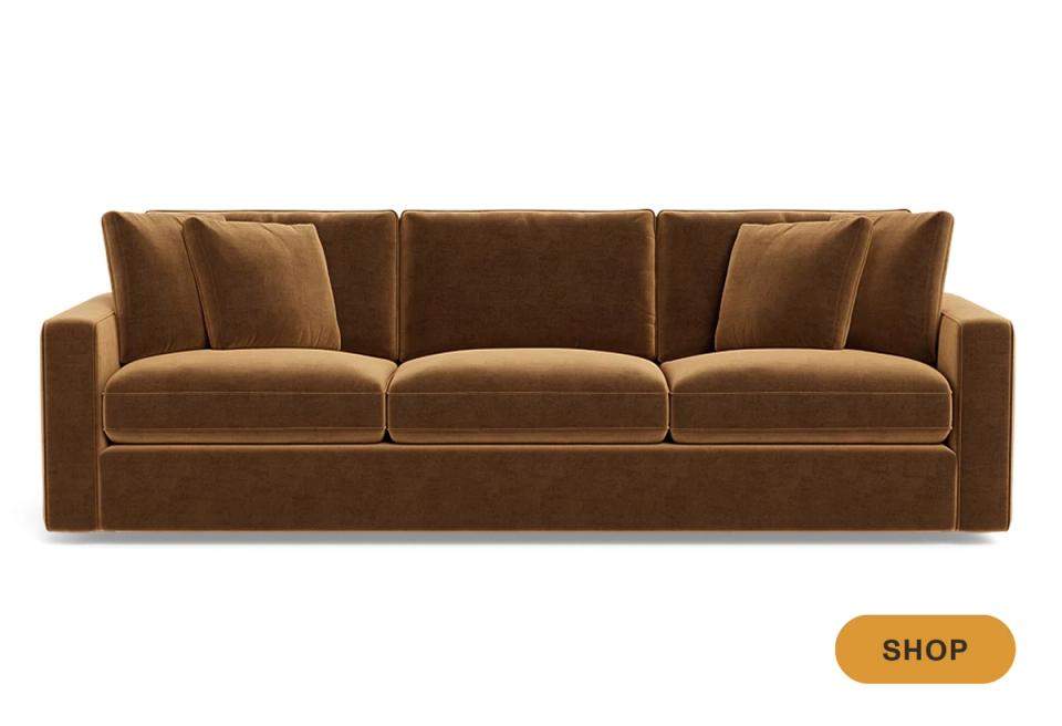 Luxe camel velvet three-seater sofa with nailhead accents and warm tones