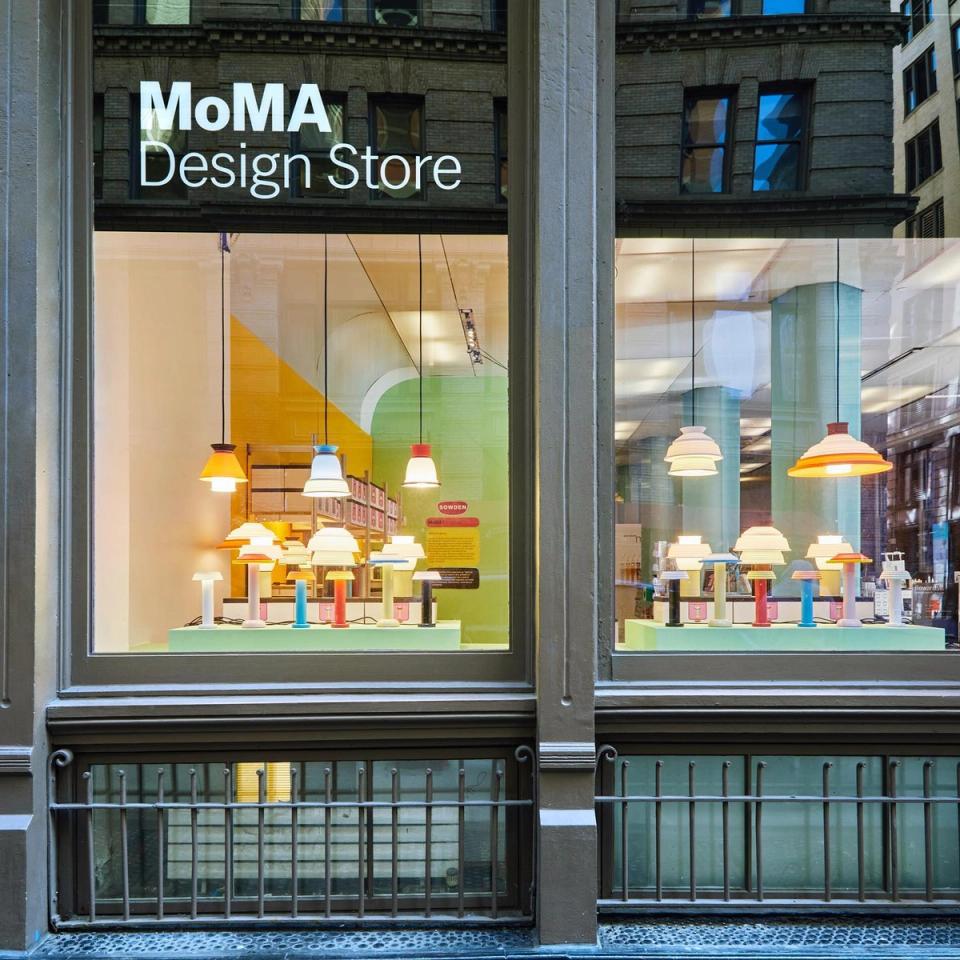 Modern design store window with colorful pendant lights and contemporary home décor displays