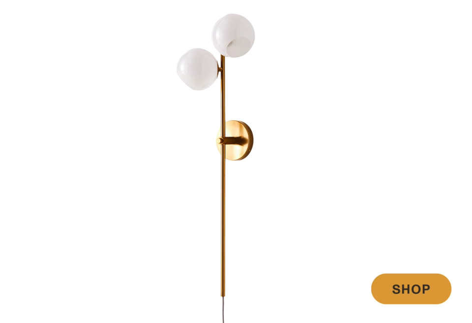 Mid-century modern brass sconce with frosted glass sphere shades