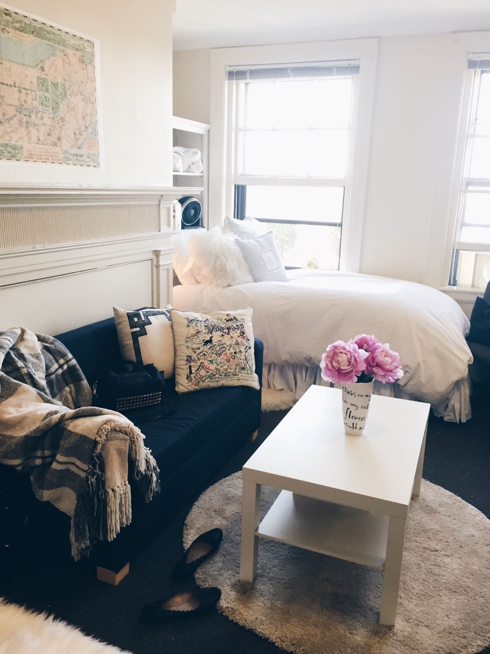 Bright, airy dorm with navy accents, natural light, and minimalist furnishings creating calm, spacious atmosphere
