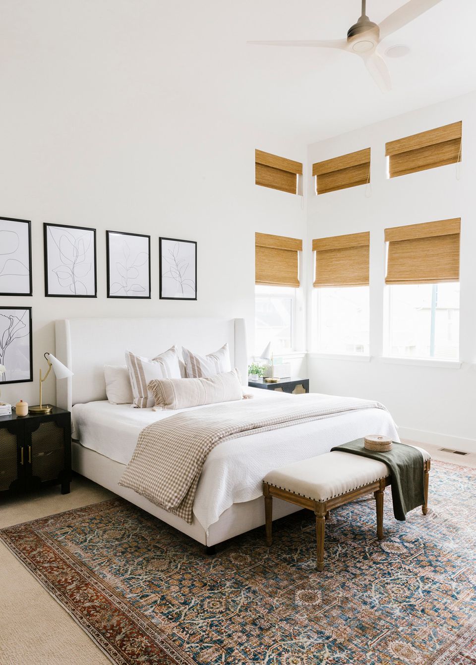 Minimalist bright bedroom with white shiplap walls, natural light, and understated coastal aesthetic