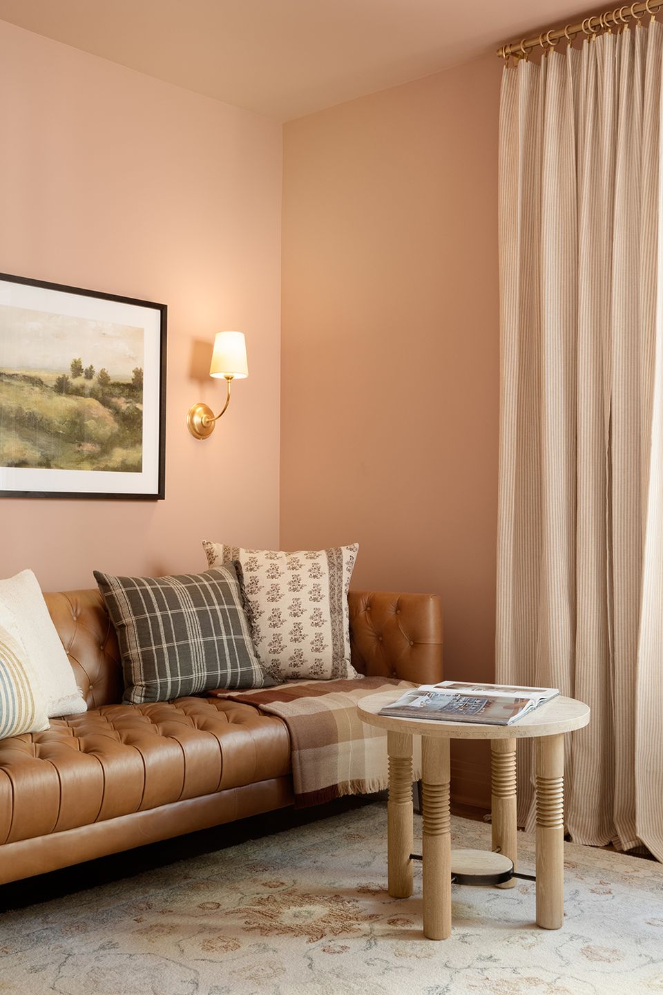 Soft peachy living room with caramel leather sofa and neutral textiles