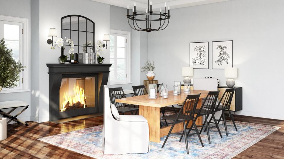 Modern farmhouse dining and living space combining warm wood tones, black fireplace focal point, and cozy plaid accents