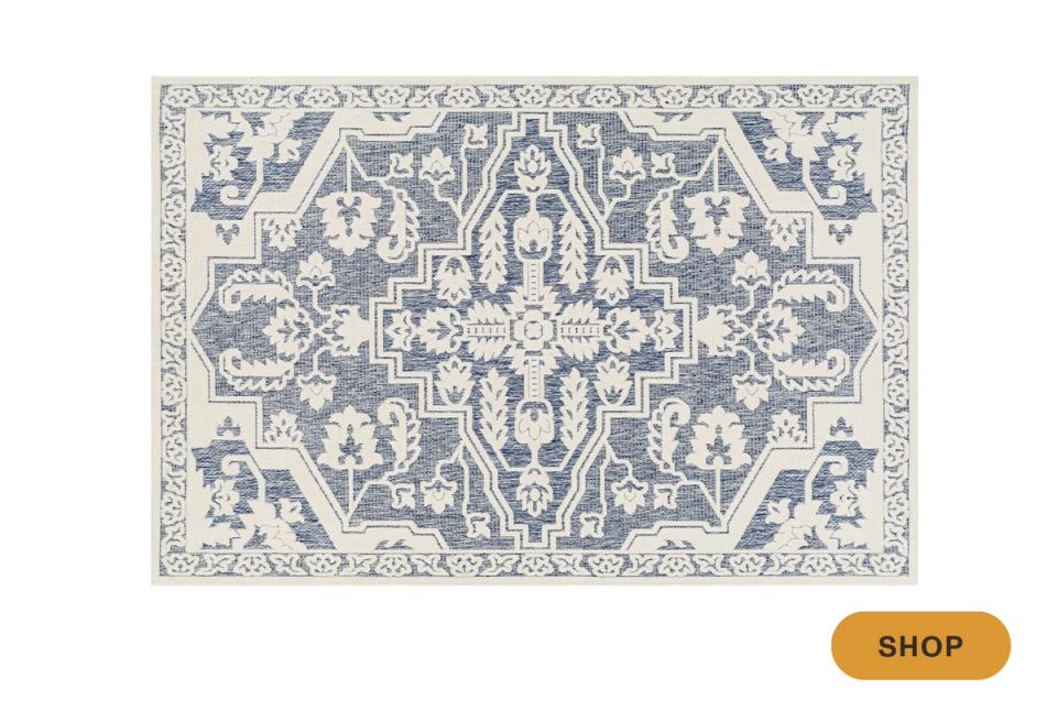 Traditional Persian-inspired rug with intricate blue and cream damask pattern