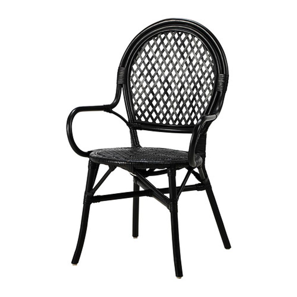 Contemporary black rattan armchair with woven backrest and curved arms