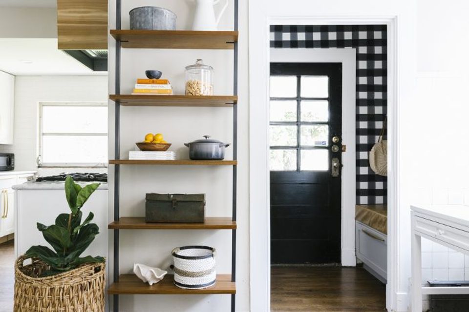 Modern farmhouse kitchen with black gingham accent wallpaper, creating bold contrast and rustic charm.