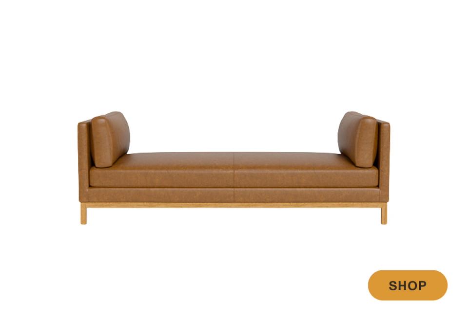 Caramel leather daybed with wooden frame and rolled arm pillows