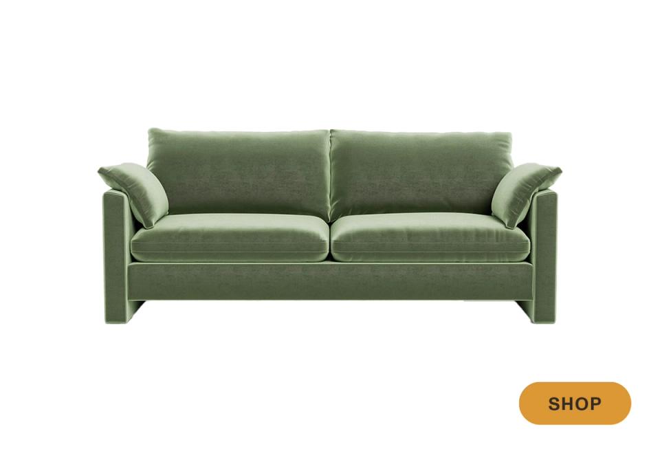 Modern sage-green performance sofa with architectural lines and upholstered arms