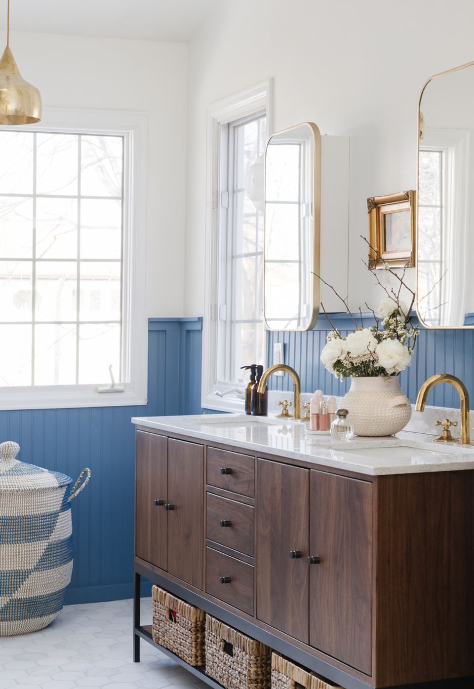 Cottage bathroom with blue beadboard, natural wood vanity, and soft neutral tones