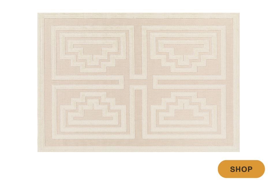 Neutral geometric outdoor rug with symmetrical Art Deco-inspired pattern in cream tones