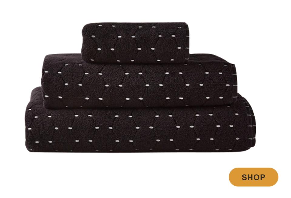 Black towels with white polka dot pattern, bold modern geometric bathroom style