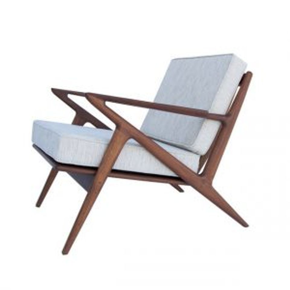 Mid-century modern wooden chair with light blue upholstery and angular frame