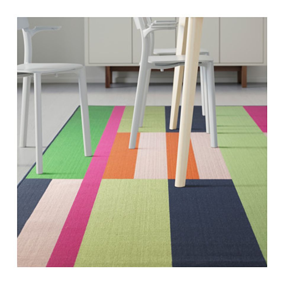 Modern workspace with bold geometric area rug in lime, pink, orange, and navy color blocking
