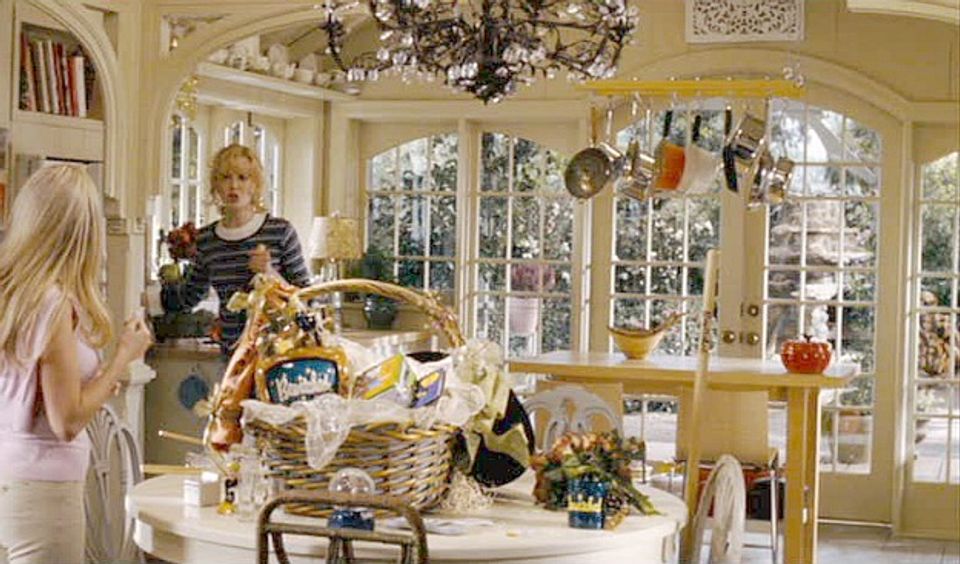 Bright sunroom with soft yellow walls, vintage charm, and eclectic collected décor creating whimsical warmth