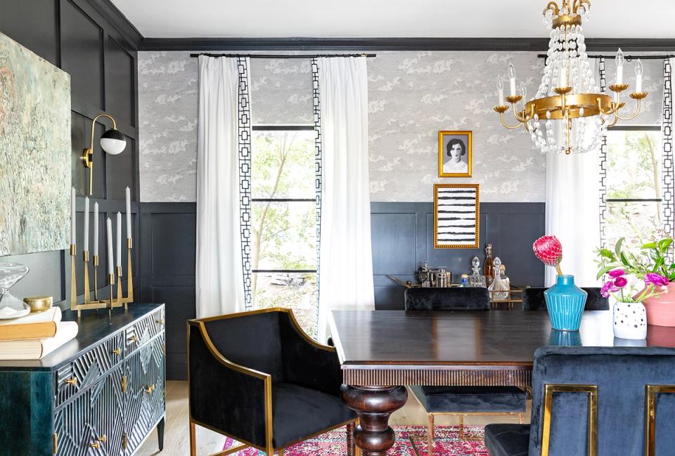 Eclectic modern home office with bold teal and navy walls, black desk, brass accents, and colorful contemporary touches