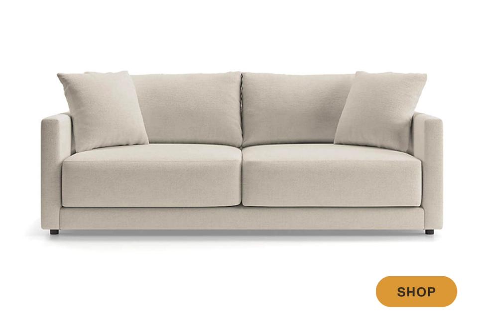 Clean-lined contemporary sofa in soft beige with deep seat cushions and track arms