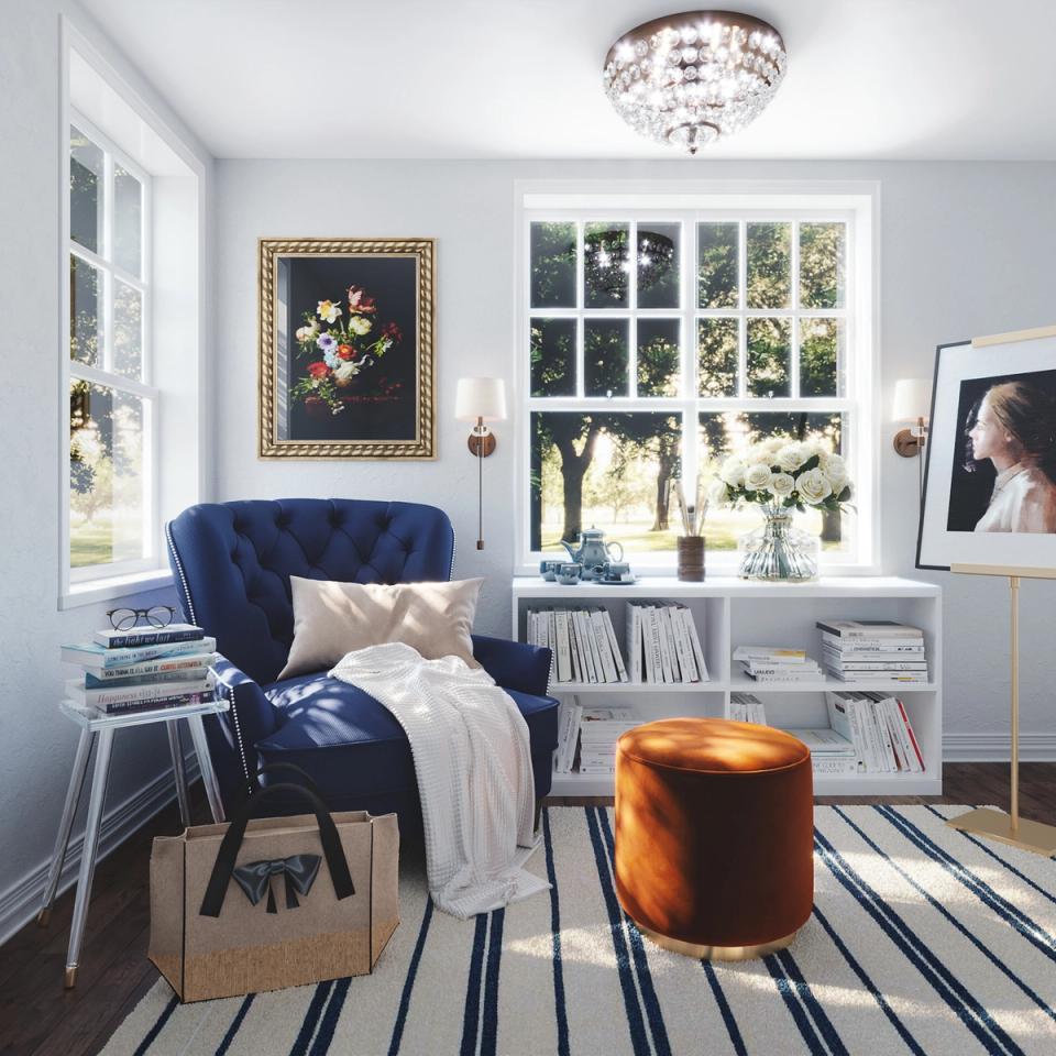 Intimate nook with navy tufted chair, striped rug, and gallery wall styling.