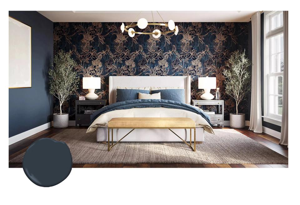 Luxe navy bedroom with ornate damask wallpaper accent wall, brass chandelier, and warm wood tones creating elegant sophistication