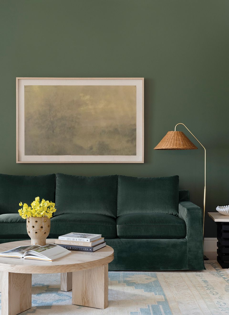 Sophisticated emerald green living room with forest sofa and warm wood coffee table