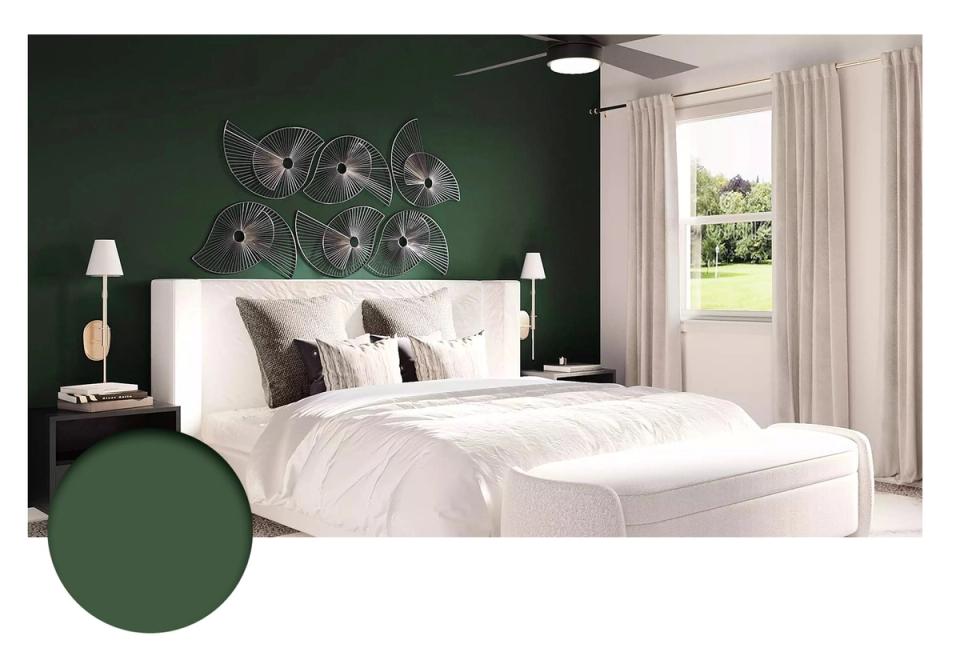 Contemporary bedroom with rich forest-green walls, crisp white bedding, and sculptural wall art creating dramatic elegance