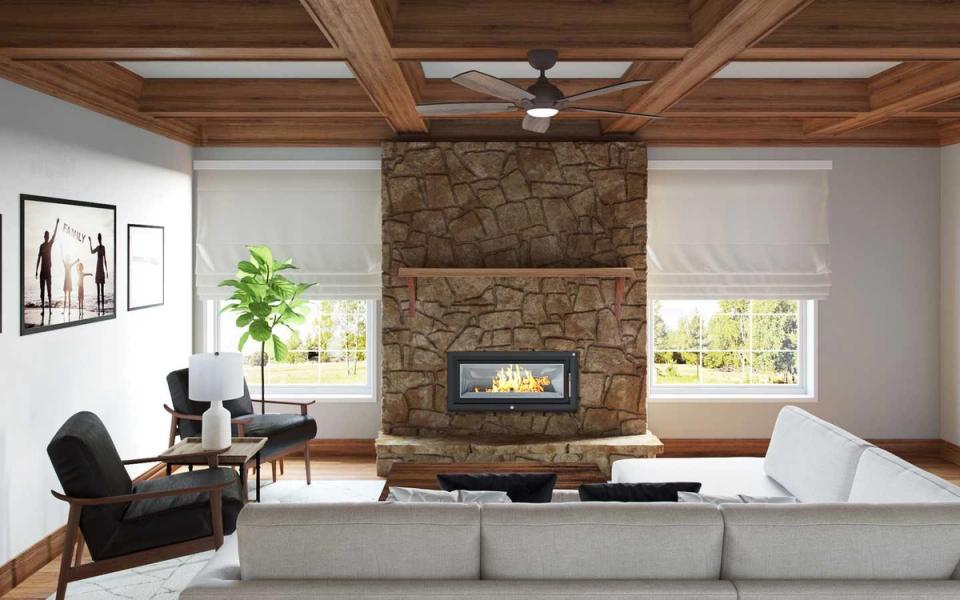 Industrial living room with exposed wood beams, stone fireplace, and neutral palette blending rustic warmth with modern minimalism