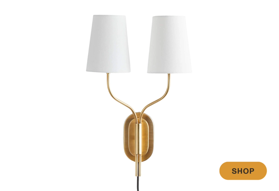 Mid-century brass double-shade wall sconce with minimalist silhouette and warm gold finish