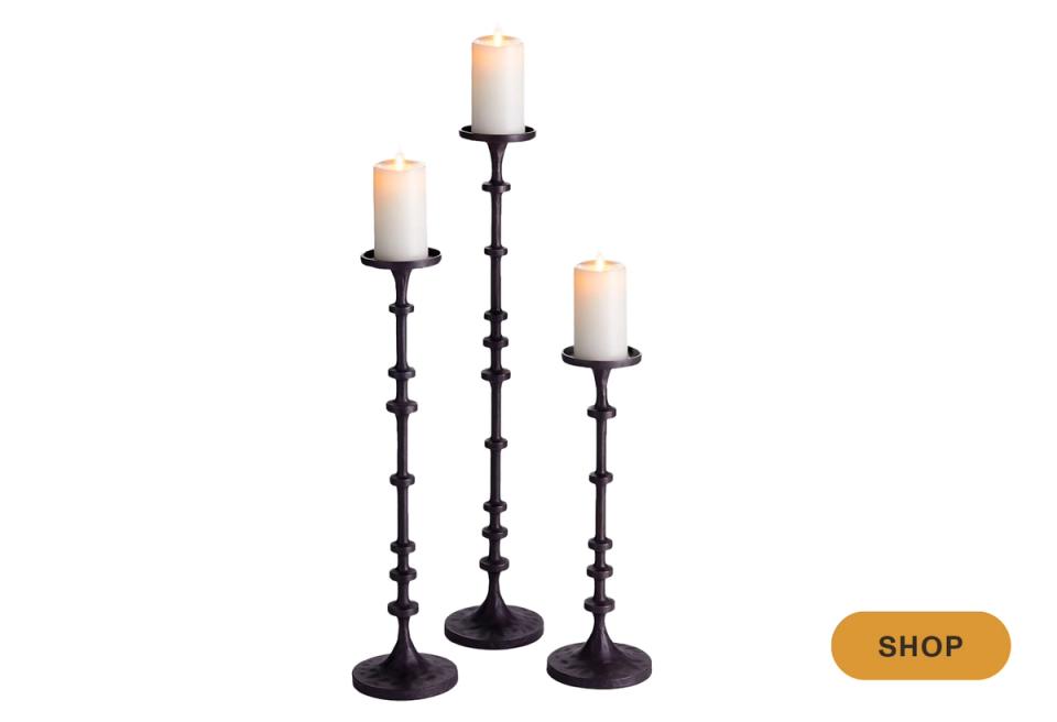 Set of three black candlestick holders with graduated heights in Gothic style