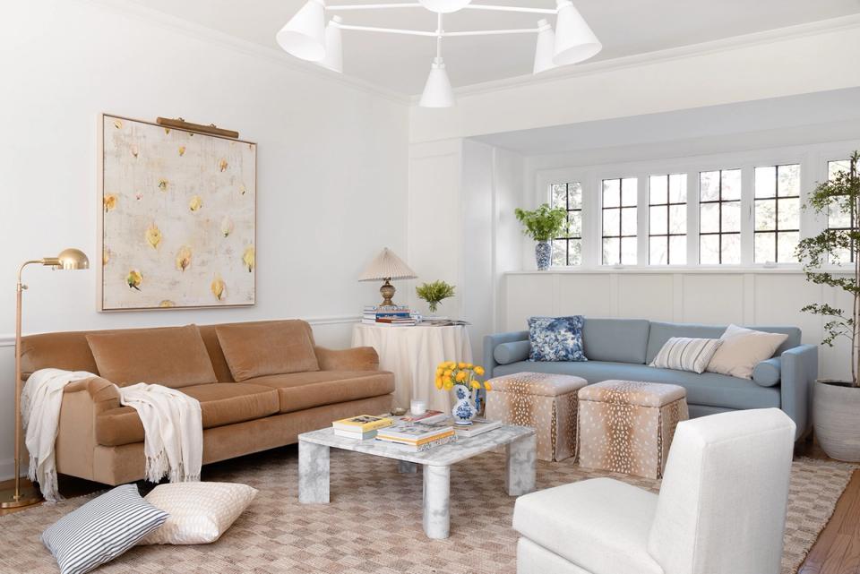 Contemporary living room mixing warm caramel and cool blue tones with open floor plan and breathing room