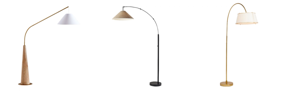 Three arc floor lamps in warm wood and matte black finishes with varied shade styles