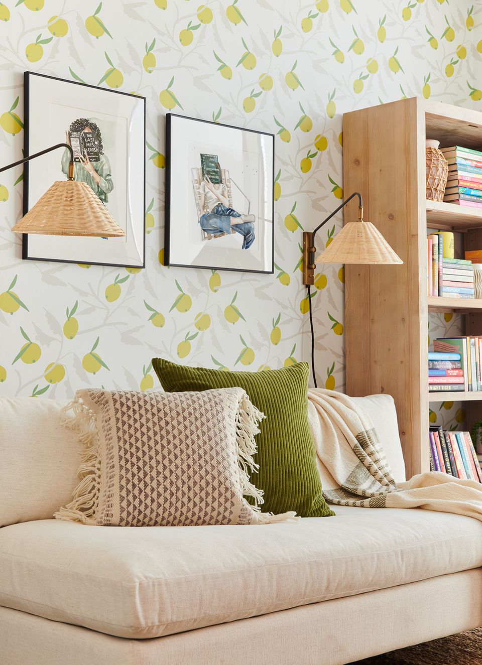 Playful botanical bedroom corner with yellow leaf wallpaper, cream daybed, green accents, and wooden floating shelves