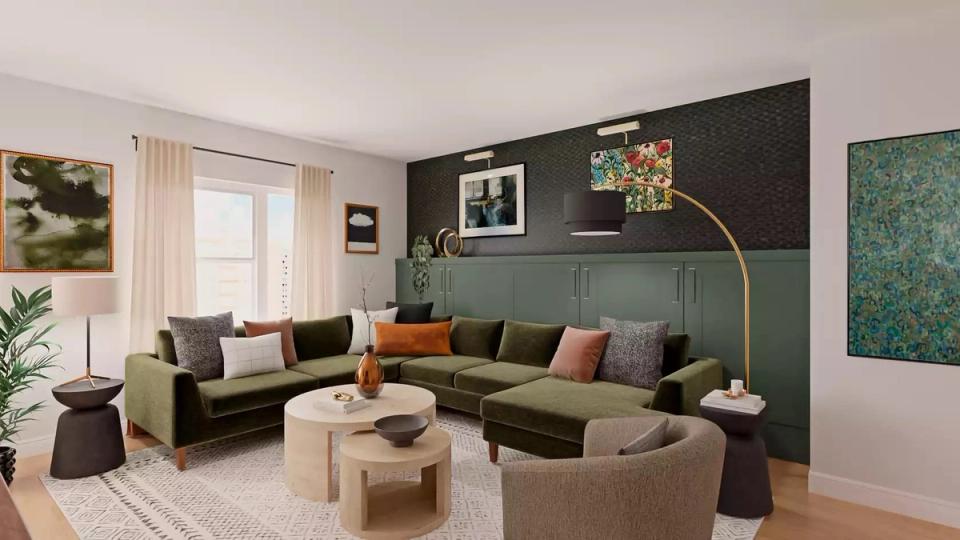 Sophisticated dark green accent wall with olive sectional, warm wood tones, and eclectic artwork
