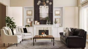 Classic living room with black fireplace accent wall, cream wingback chairs, dark sofa, and symmetrical gallery styling creating timeless elegance
