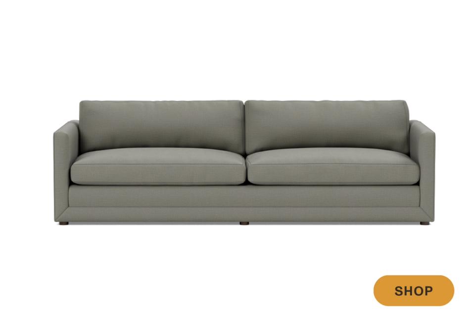 Contemporary gray upholstered sofa with clean lines and streamlined silhouette against white background