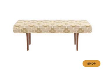 Mid-century bench with cream botanical print and warm wood legs