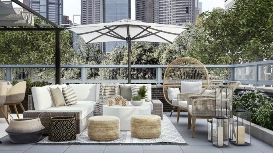 Modern urban rooftop patio with neutral palette, natural textures, and lush greenery creating sophisticated outdoor living.