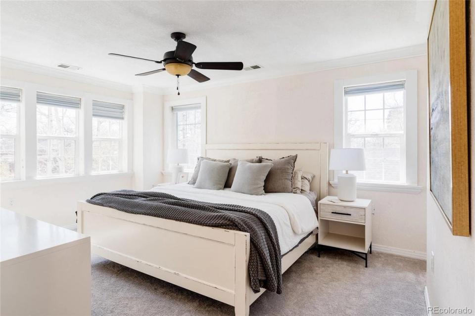 Bright, airy primary bedroom with cream bedframe and soft neutral tones throughout