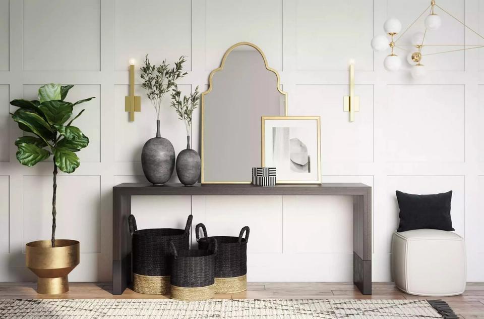 Scandinavian-modern foyer with natural wood, brass accents, and suspended geometric lights