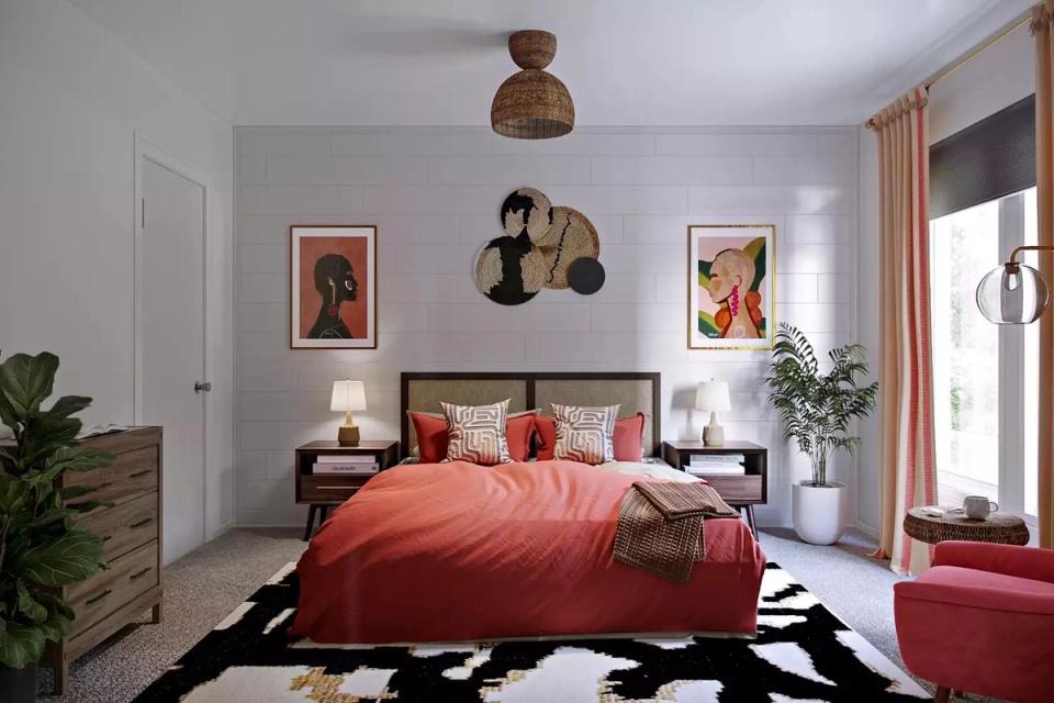 Contemporary bedroom mixing mid-century warmth with bold coral bedding, geometric black-and-white rug, and curated wall art