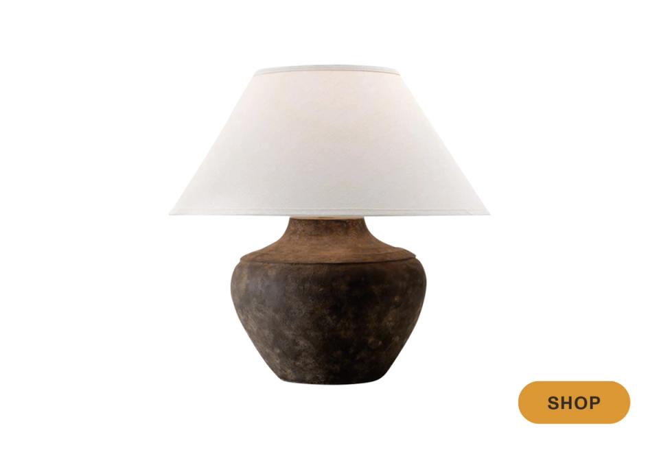 Rustic-modern table lamp pairing dark ceramic base with crisp cream linen shade