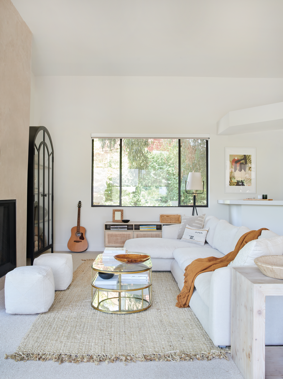 Light-filled modern living room with cream seating, natural wood accents, and organic curved furniture pieces