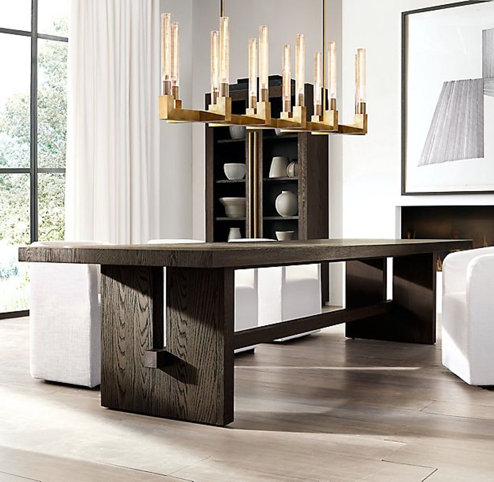 Contemporary dining with sculptural brass chandelier, dark wood table, and sophisticated neutral palette