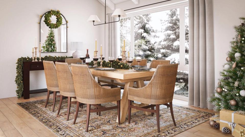 Warm mid-century dining room with natural wood table, woven chairs, greenery garland, and cozy holiday ambiance