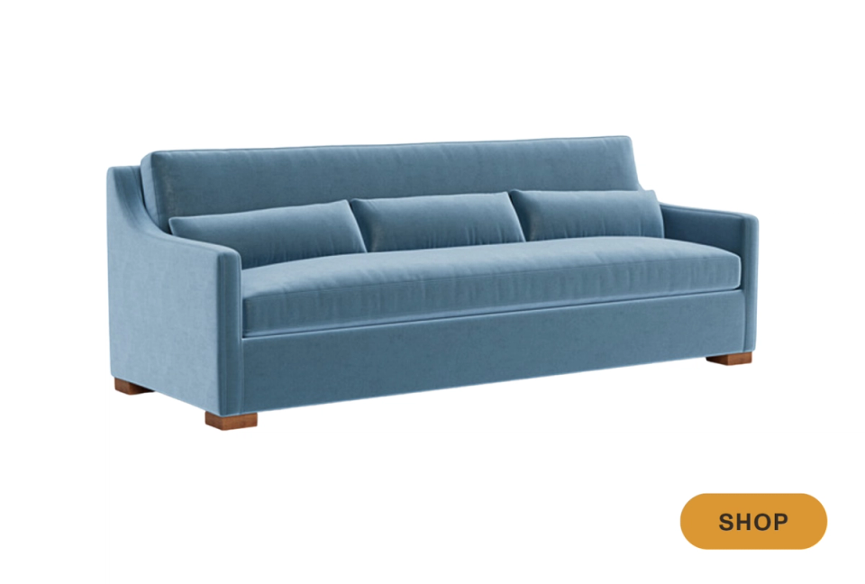Refined blue-gray sofa with sloped arms and warm wood feet in classic transitional style