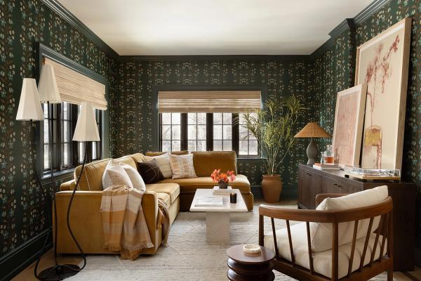 Warm mid-century modern living room with dark geometric wallpaper, mustard sofa, and wood furniture