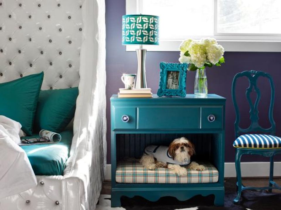 Jewel-toned teal nightstand with integrated pet crate in eclectic bedroom
