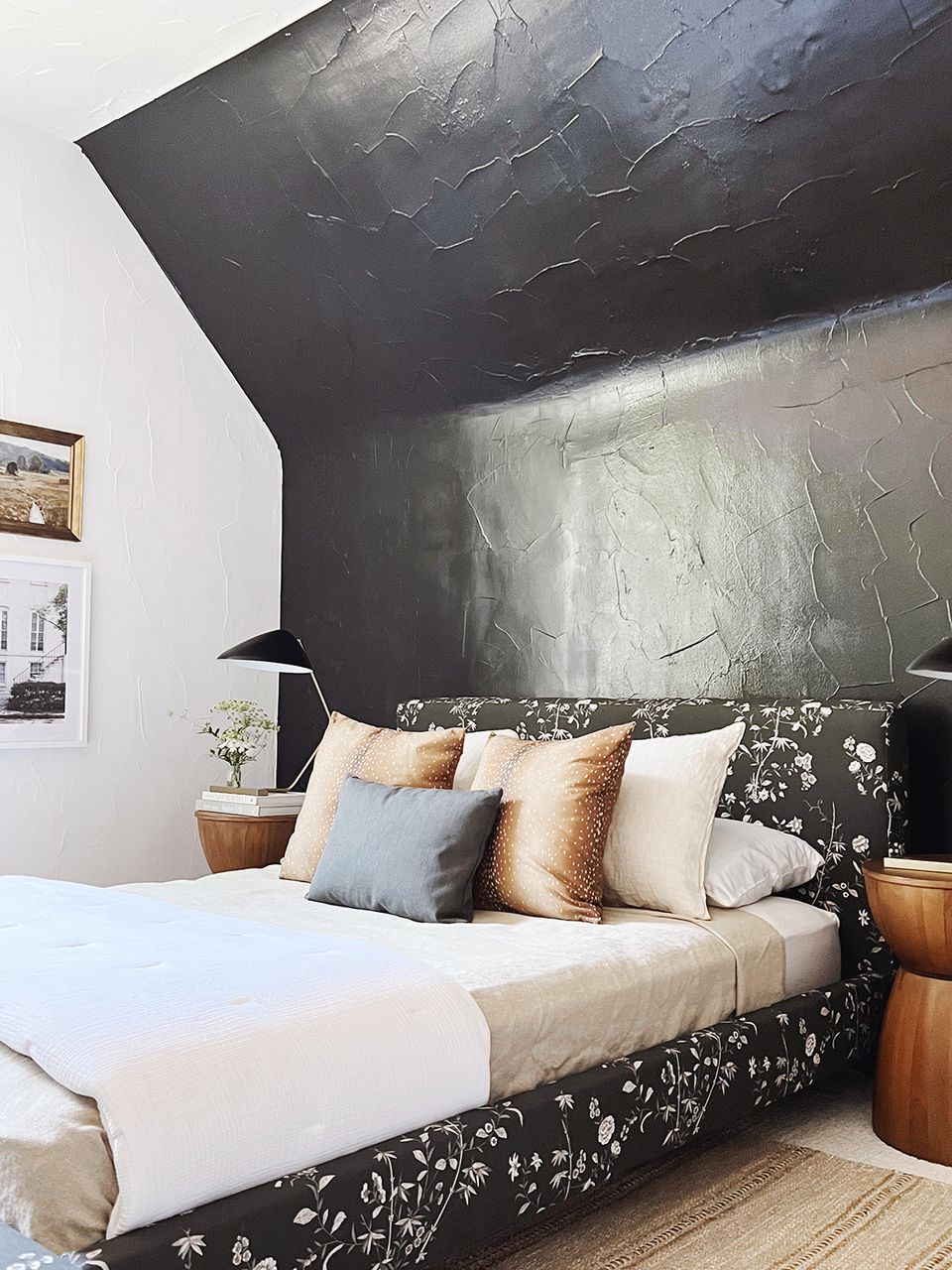 Artistic modern bedroom: dramatic dark geometric wall art, black patterned bedframe, warm wood accents