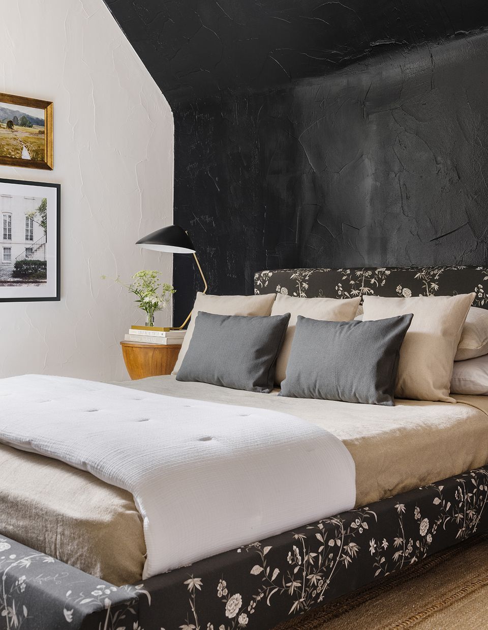 Modern eclectic bedroom with dramatic black marble headboard and layered neutral textures