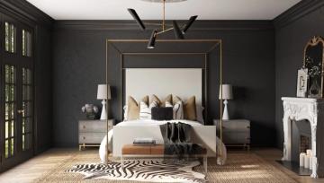 Luxe modern bedroom with charcoal walls, layered neutral and zebra-print rugs, brass-framed mirror headboard, and brass pendant lighting.