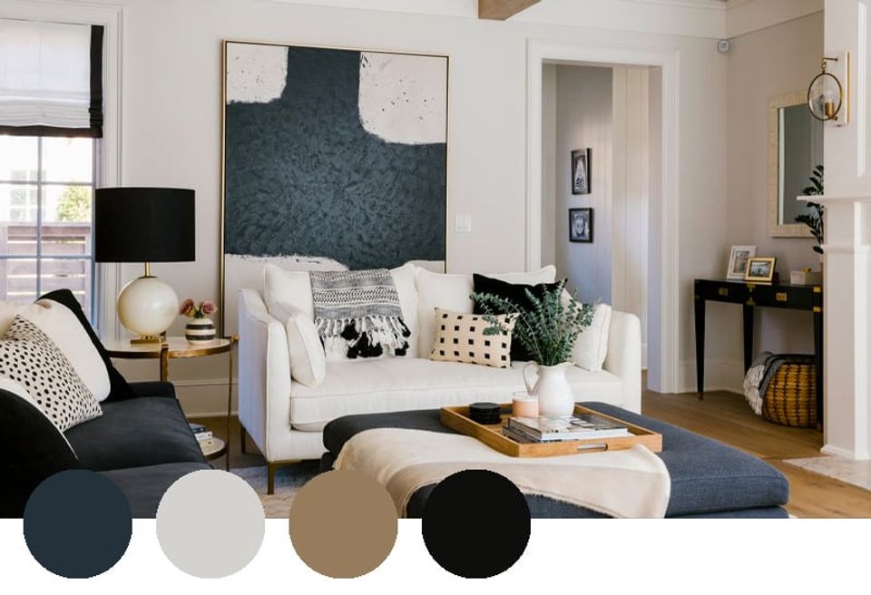 Modern living room blending navy, cream, and natural wood tones with minimalist artwork and textured upholstery for sophisticated depth